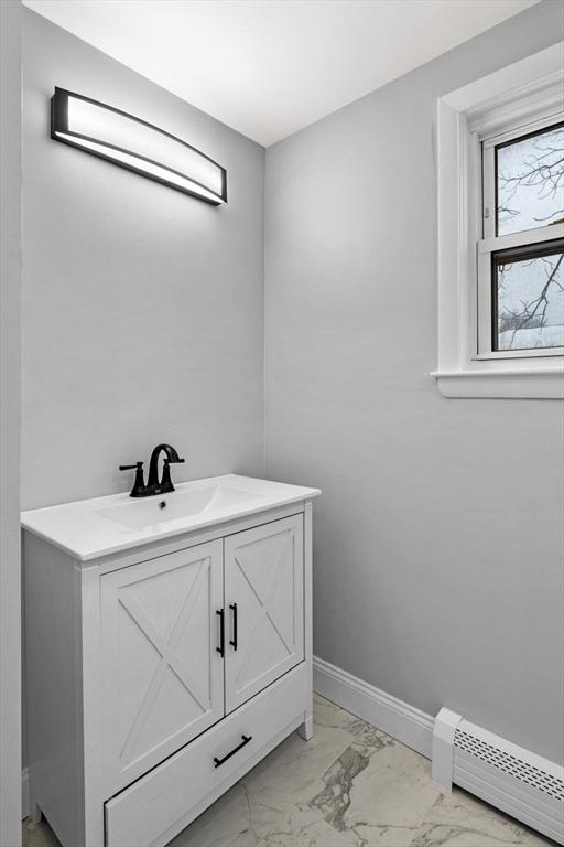 bathroom with baseboard heating and vanity