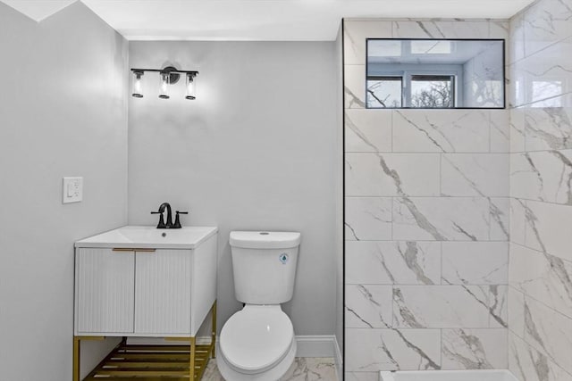 bathroom featuring tiled shower, toilet, and vanity