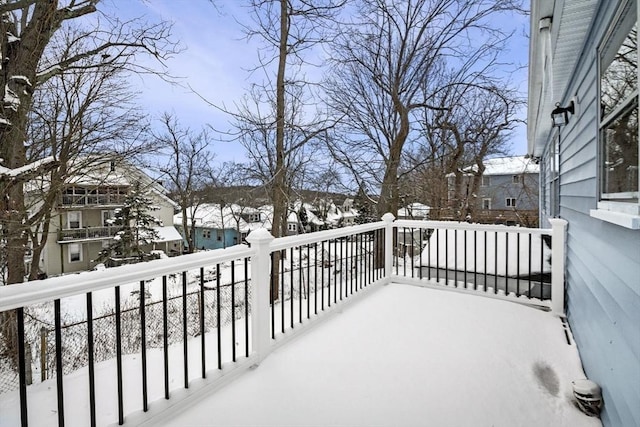 view of snow covered back of property