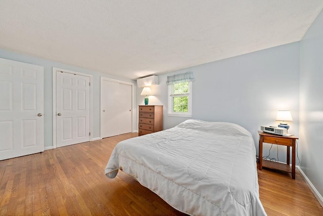 1102 State Rd, Plymouth, MA 02360 - bedroom featuring wood finished floors and a wall unit AC