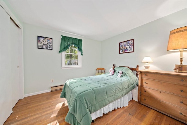 1102 State Rd, Plymouth, MA 02360 - bedroom featuring baseboard heating, hardwood / wood-style flooring, and a closet