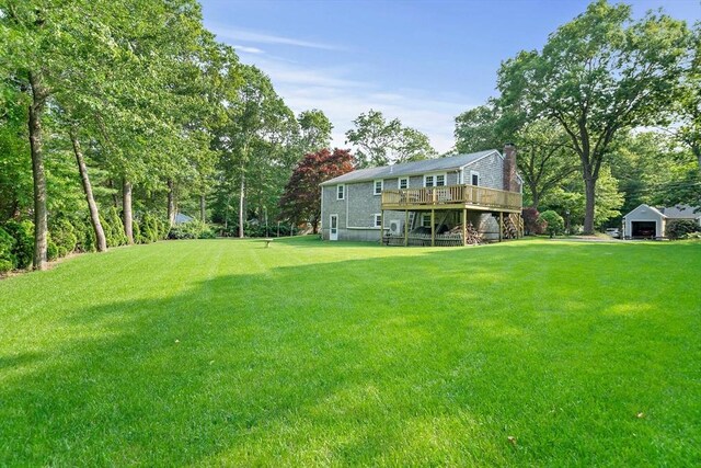 1102 State Rd, Plymouth, MA 02360 - view of green lawn featuring a wooden deck, an outdoor structure, and a detached garage