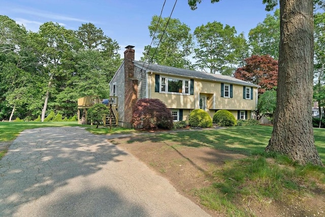 1102 State Rd, Plymouth, MA 02360 - raised ranch featuring a chimney, asphalt driveway, a front yard, and stairs