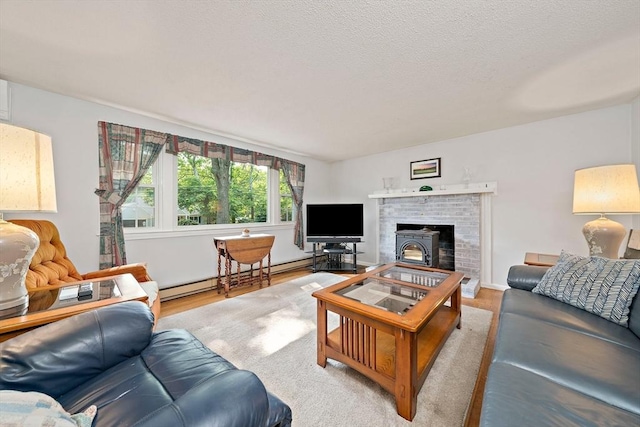 1102 State Rd, Plymouth, MA 02360 - living area featuring baseboard heating, wood finished floors, and a fireplace
