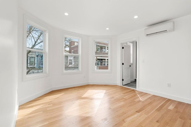63 Oak St Unit 2, Somerville, MA 02143 - empty room with an AC wall unit, light wood finished floors, baseboards, and recessed lighting