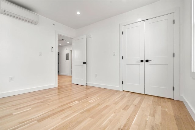 63 Oak St Unit 2, Somerville, MA 02143 - unfurnished bedroom featuring a wall unit AC, light wood-style flooring, recessed lighting, baseboards, and a closet