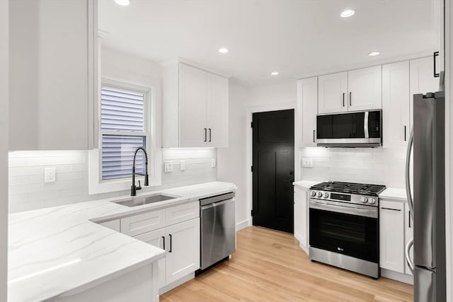 63 Oak St Unit 2, Somerville, MA 02143 - kitchen featuring stainless steel appliances, a sink, backsplash, and recessed lighting