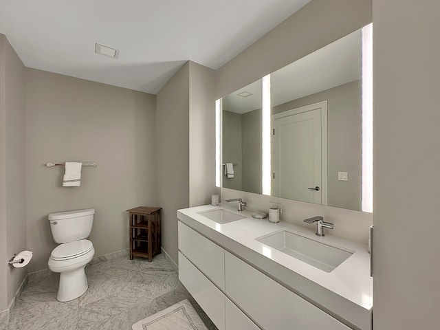 bathroom with toilet, tile patterned floors, and dual bowl vanity