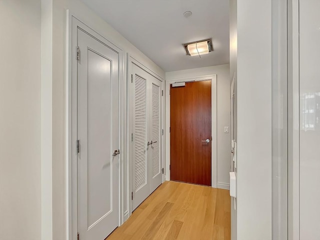 hall with light hardwood / wood-style floors