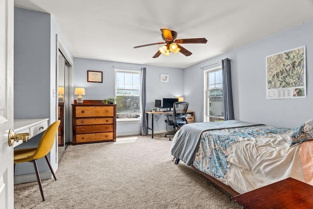 bedroom featuring a ceiling fan and light colored carpet