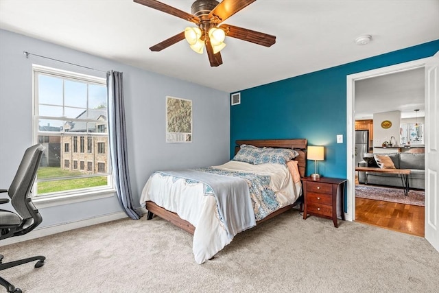 bedroom with visible vents, carpet flooring, ceiling fan, and multiple windows