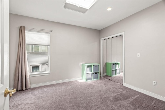 unfurnished bedroom featuring recessed lighting, baseboards, carpet, and a closet