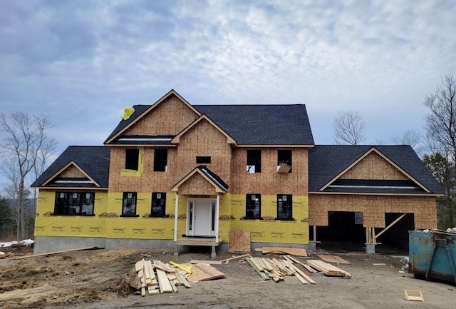 property under construction featuring a garage and a shingled roof