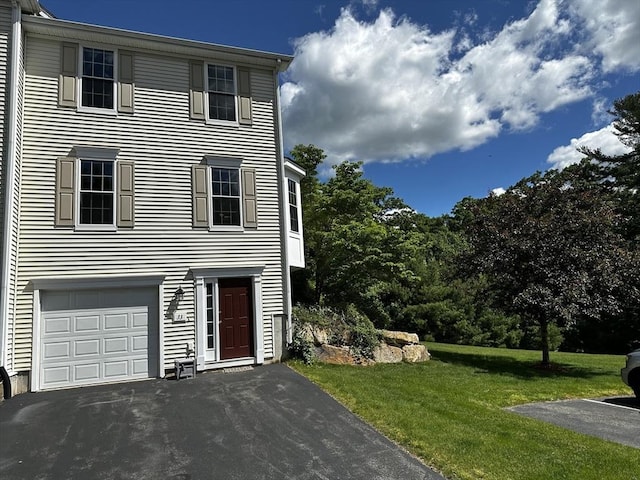 view of front facade with a garage, driveway, and a front lawn