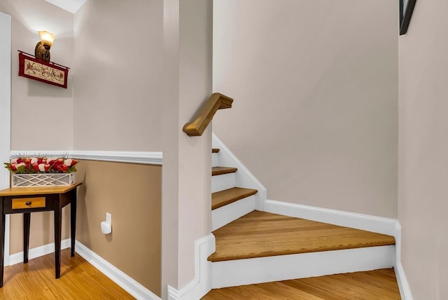 stairs featuring baseboards and wood finished floors