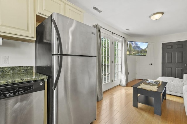226-236 River St Unit 5, Haverhill, MA 01832 - kitchen with appliances with stainless steel finishes, cream cabinets, light wood-style floors, and dark stone counters