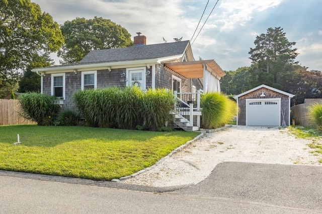 view of front facade with a garage, an outdoor structure, and a front yard