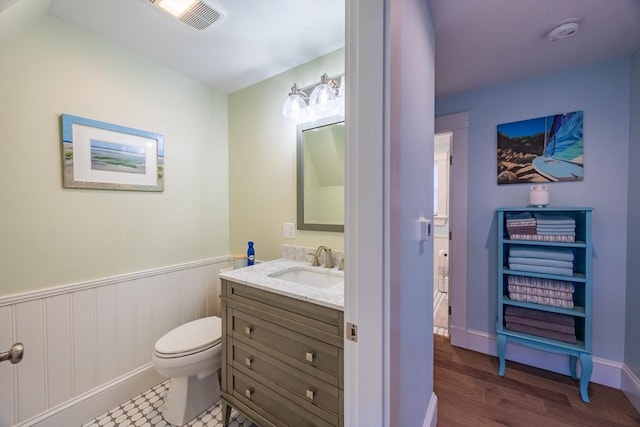 bathroom featuring vanity, hardwood / wood-style floors, and toilet