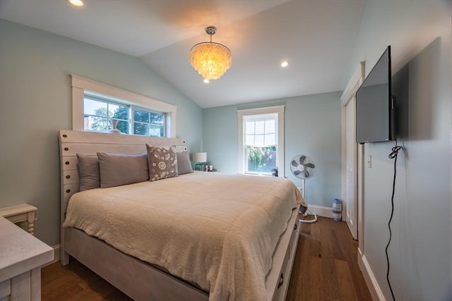 bedroom featuring lofted ceiling, dark hardwood / wood-style flooring, and a notable chandelier