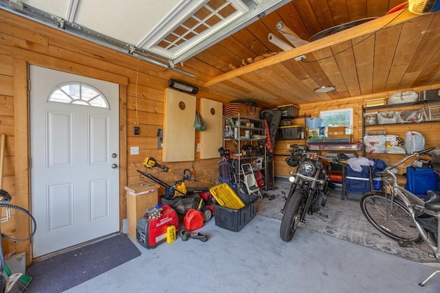 garage with wooden ceiling and wooden walls