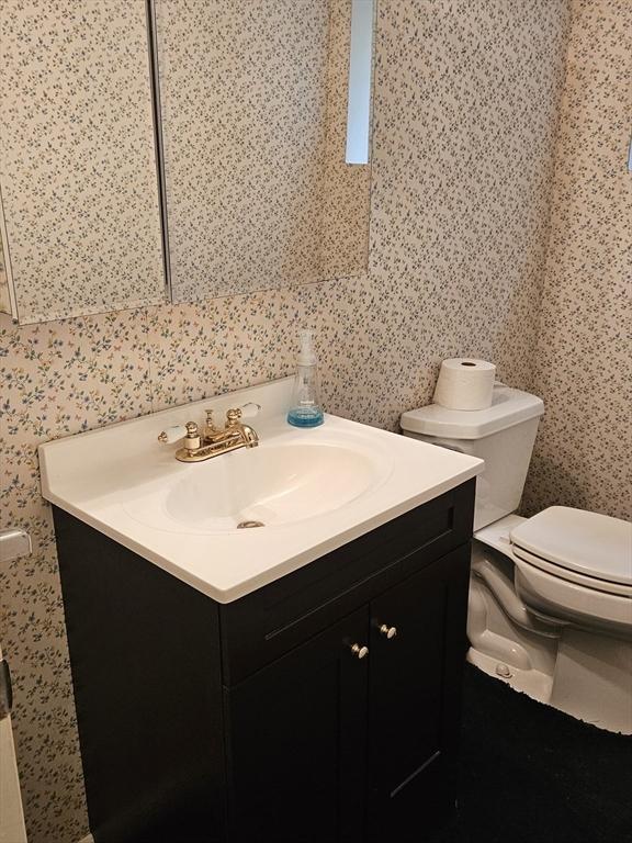 59 Tanbark Rd, Sudbury, MA 01776 - bathroom with toilet, vanity, and wallpapered walls