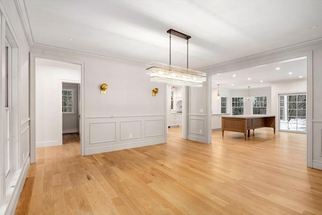 spare room featuring light wood-style floors, ornamental molding, a decorative wall, and recessed lighting