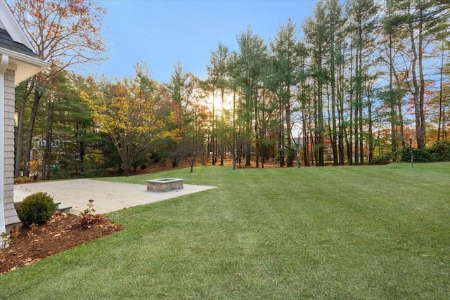 view of yard featuring an outdoor fire pit and a patio area