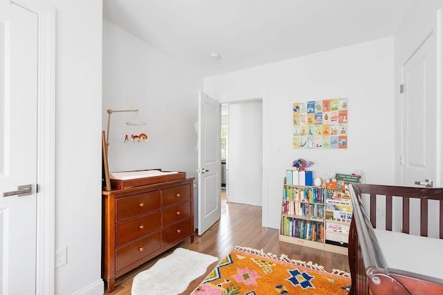 bedroom featuring light wood-style flooring and baseboards