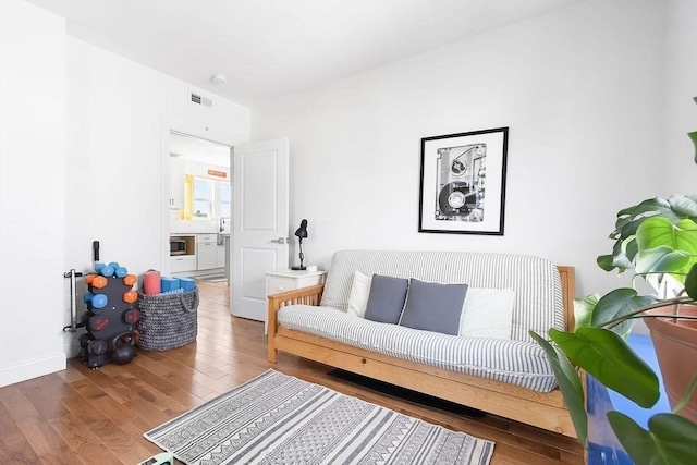 living room featuring wood finished floors and baseboards