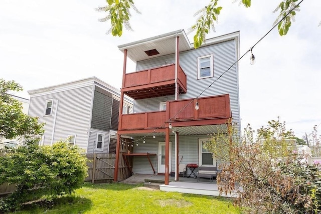 back of house featuring a balcony