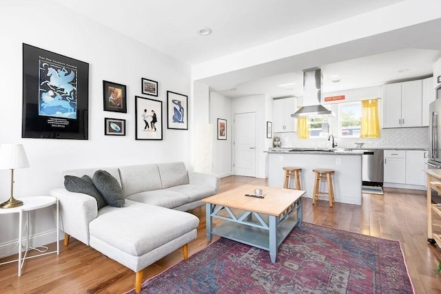 living area with light wood-type flooring and recessed lighting