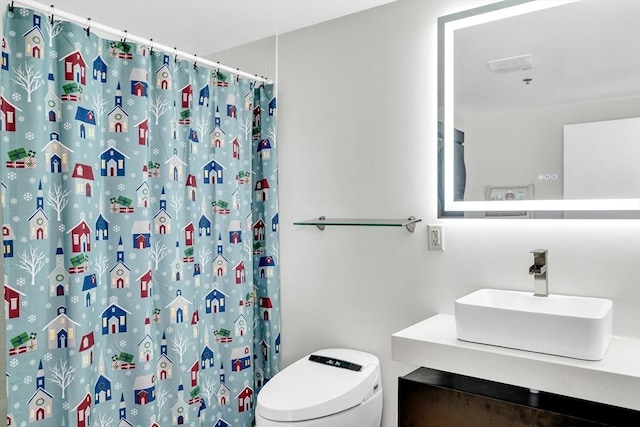 bathroom with toilet, vanity, and a shower with shower curtain