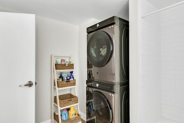 washroom featuring stacked washer / dryer