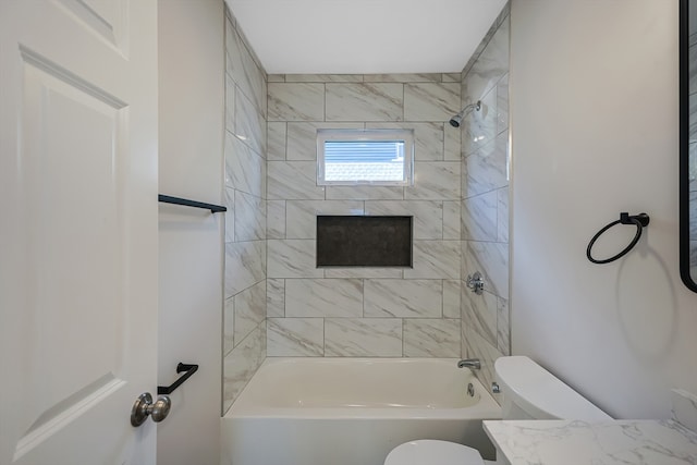 full bathroom featuring vanity, toilet, and tiled shower / bath