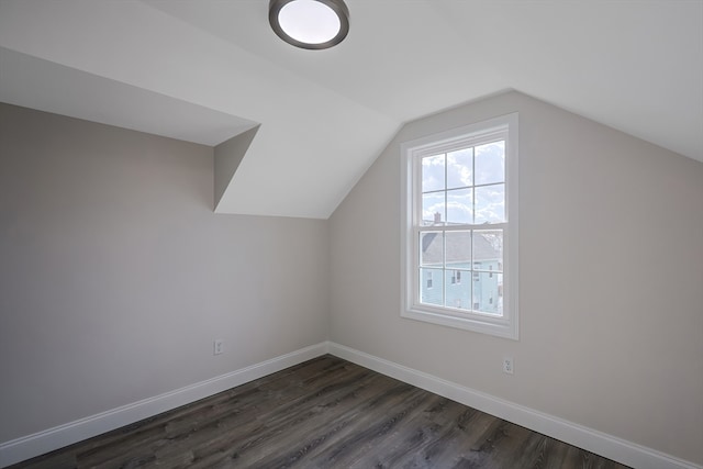 additional living space featuring lofted ceiling and dark hardwood / wood-style floors