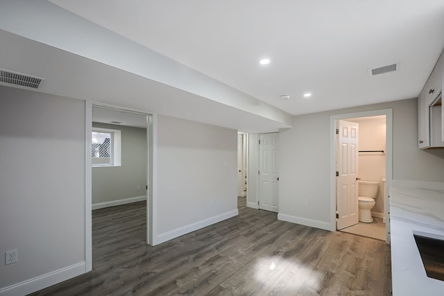 basement featuring dark hardwood / wood-style flooring