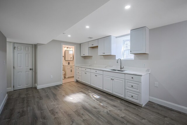 kitchen with sink, dark hardwood / wood-style floors, and white cabinets