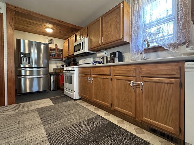44-46 Spring St, West Springfield, MA 01089 - kitchen featuring white appliances, brown cabinetry, light countertops, wooden ceiling, and a sink