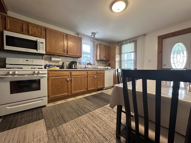 44-46 Spring St, West Springfield, MA 01089 - kitchen featuring white appliances, brown cabinetry, and light countertops