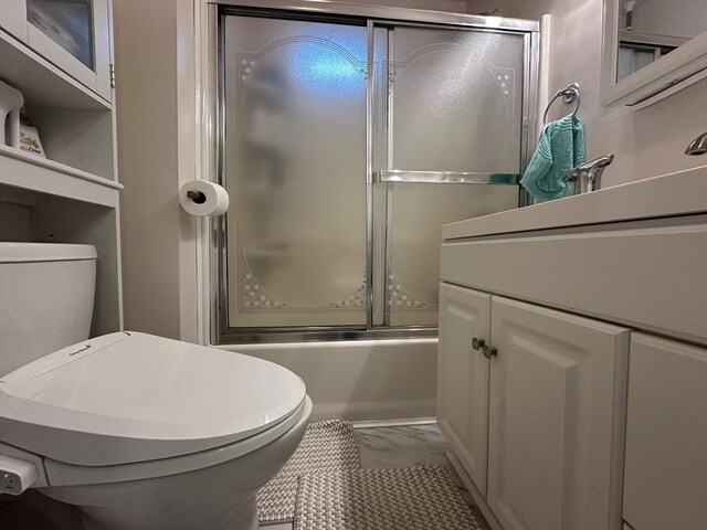 44-46 Spring St, West Springfield, MA 01089 - full bathroom featuring marble finish floors, toilet, vanity, and shower / bath combination with glass door
