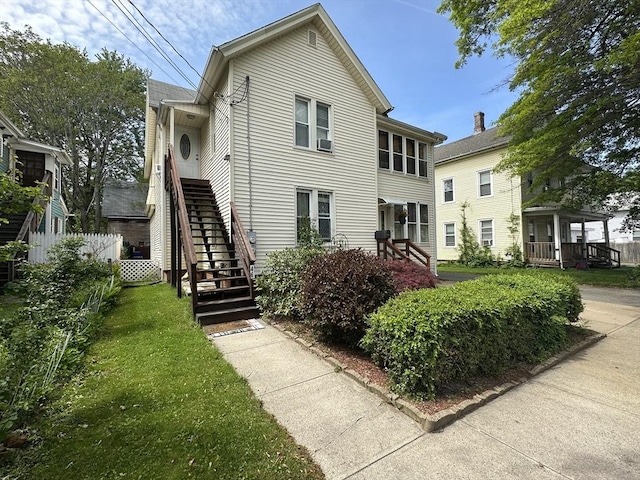 44-46 Spring St, West Springfield, MA 01089 - view of front of house featuring stairway and a front lawn