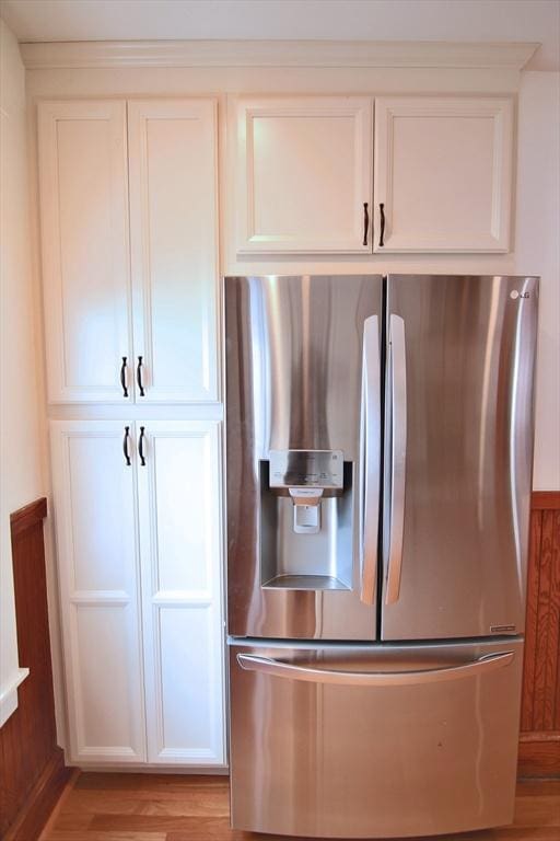 kitchen featuring light wood-type flooring, white cabinets, and stainless steel fridge with ice dispenser