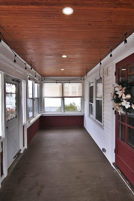 unfurnished sunroom featuring wooden ceiling