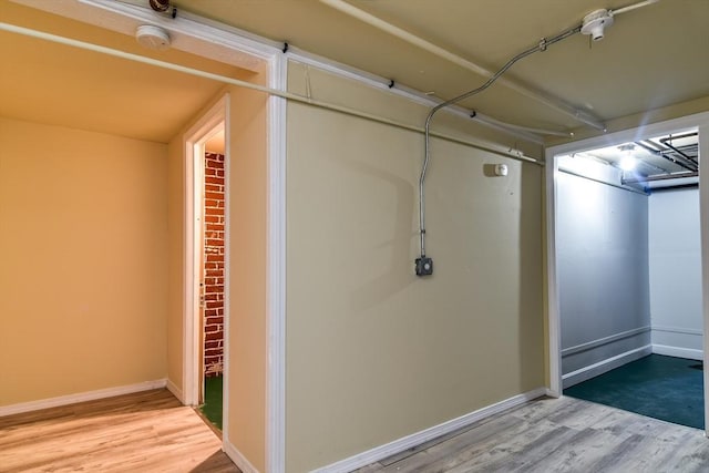 finished below grade area with wood finished floors and baseboards