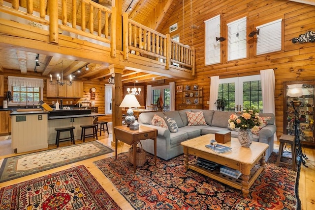 7 Rileys Way, Dartmouth, MA 02747 - living area with light wood-style flooring, wood ceiling with exposed beams, a chandelier, and a high ceiling