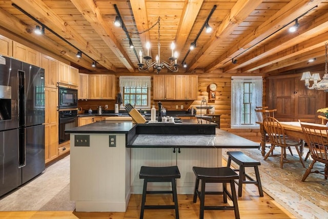 7 Rileys Way, Dartmouth, MA 02747 - kitchen featuring rail lighting, black appliances, a chandelier, plenty of natural light, and log walls