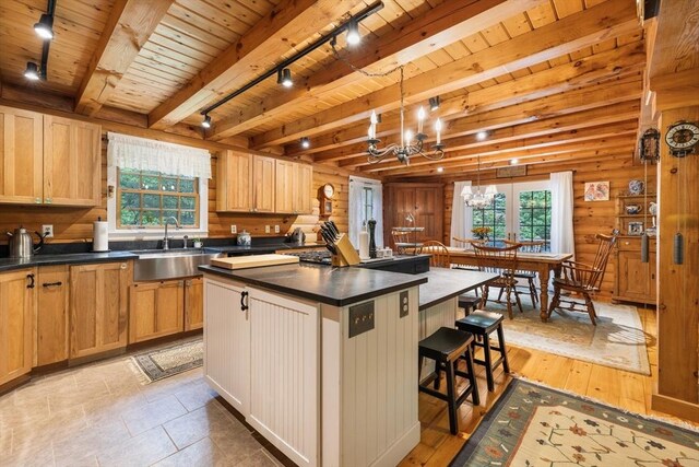 7 Rileys Way, Dartmouth, MA 02747 - kitchen featuring wooden ceiling with exposed beams, a sink, a kitchen island, dark countertops, and a chandelier