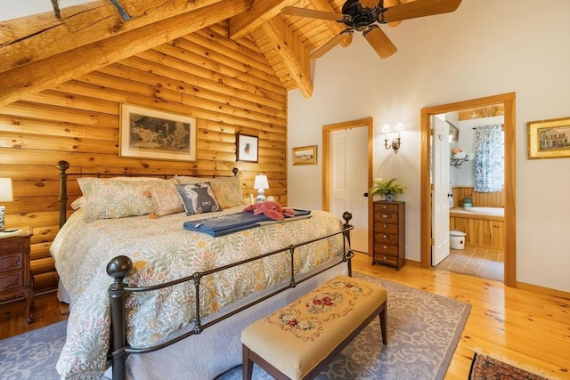 7 Rileys Way, Dartmouth, MA 02747 - bedroom featuring beamed ceiling, light wood-style flooring, high vaulted ceiling, rustic walls, and ensuite bathroom