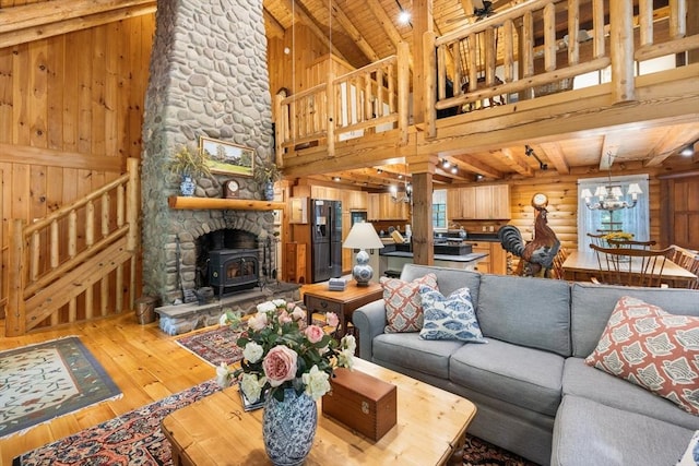 7 Rileys Way, Dartmouth, MA 02747 - living area featuring hardwood / wood-style flooring, a wood stove, wood ceiling with exposed beams, wood walls, and stairs