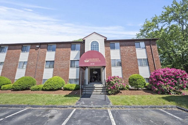 1410 Skyline Dr Unit 11, Lowell, MA 01854 - view of building exterior featuring uncovered parking